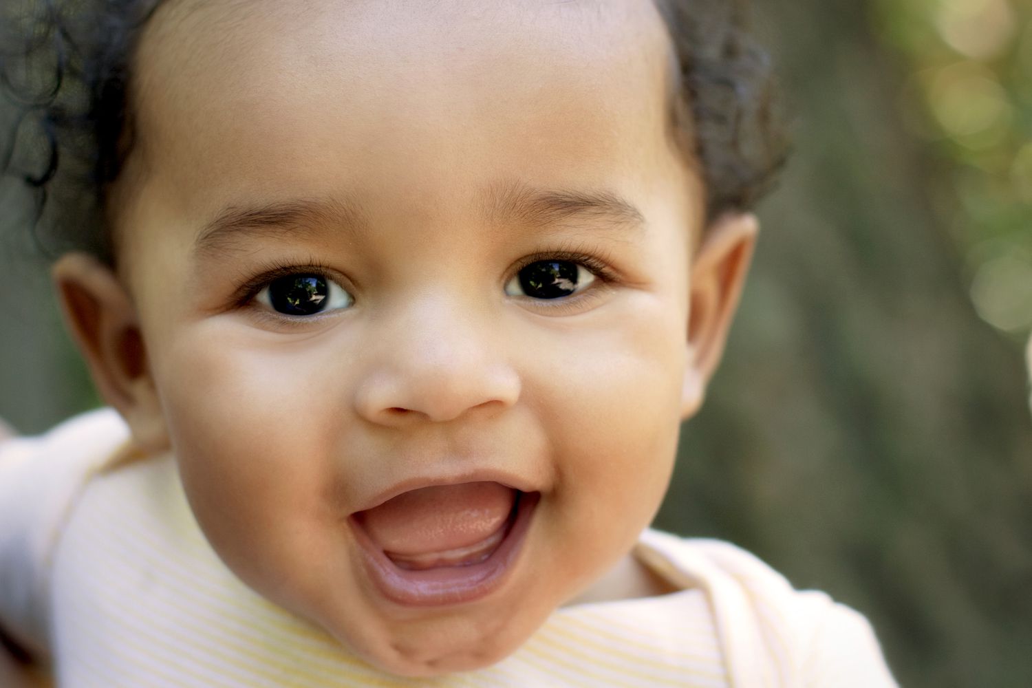 Baby of African American descent looking at the camera, close-up