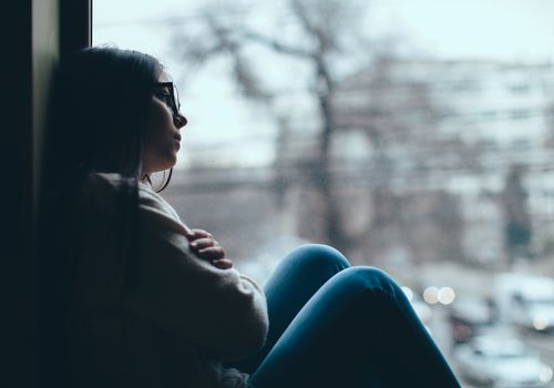 upset girl in window