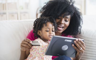 Mother and daughter shopping on tablet computer
