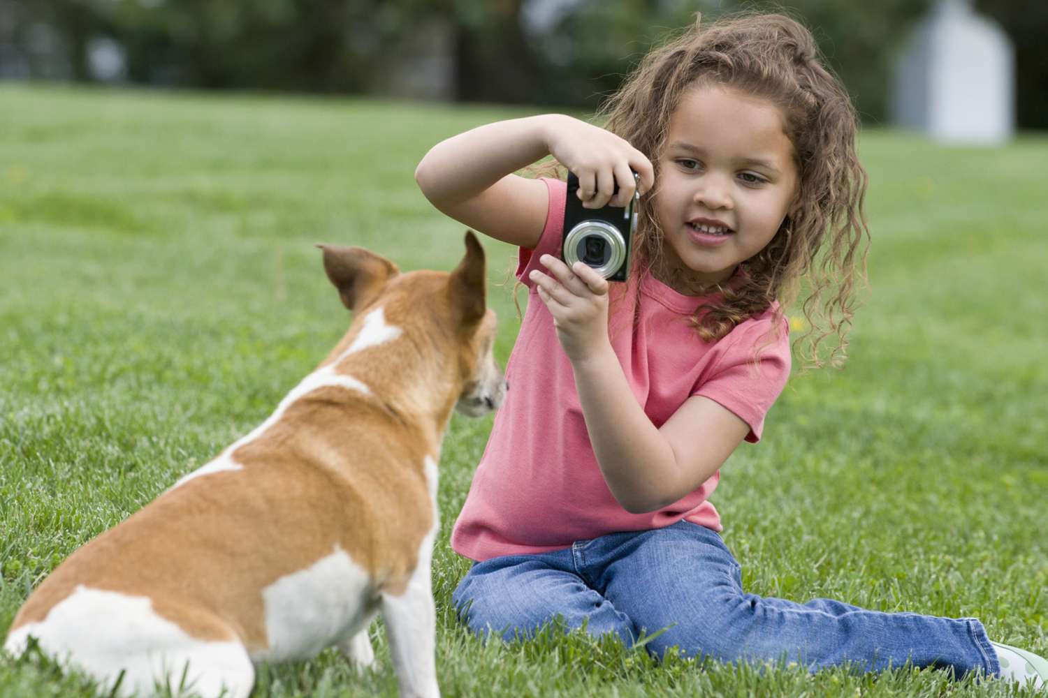A girl using a camera outside.