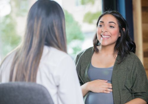 Woman discussing her prenatal care with doctor