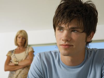 Boy upset, mother in the background