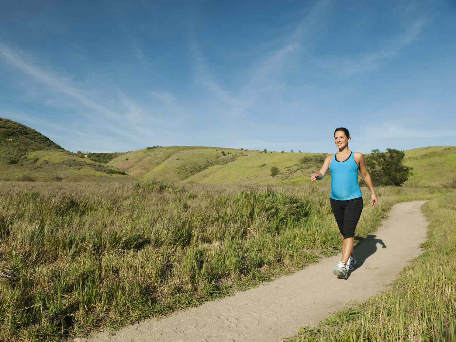 Pregnant woman walking in remote area