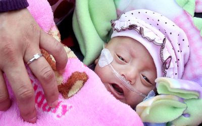 Haydee Ibarra, 22, covers her daughter Melinda Star Guido with her blanket as they leave the Los Angeles County-USC Medical Center January 20, 2012 in Los Angeles, California. Melinda Star Guido, the third smallest surviving baby known in the world, was born on August 30, 2011 weighing only 9.5 ounces.