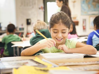 second grade girl in classroom smiling