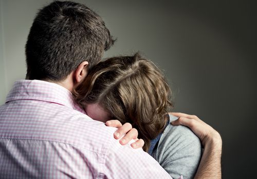 Couple comforting each other after sad news