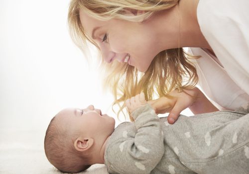 mother playing with baby