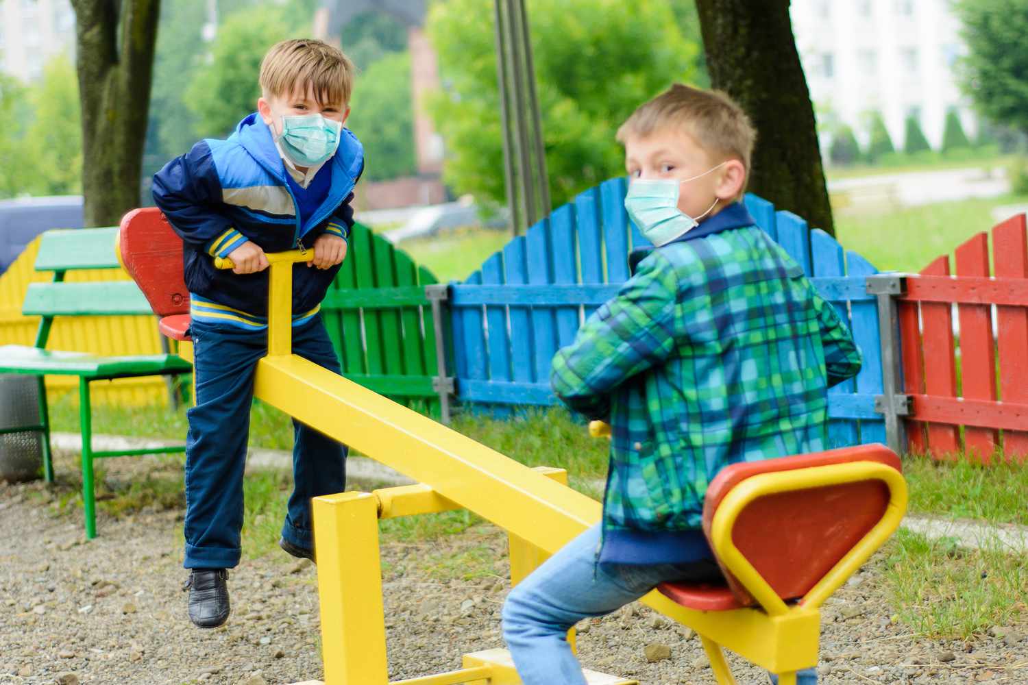 little boys playing on seesaw