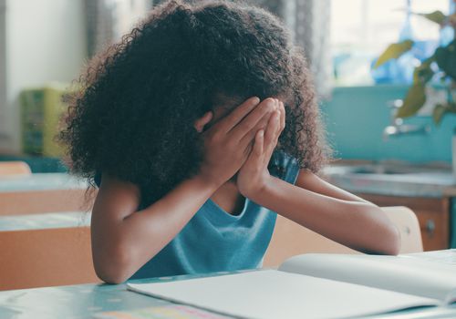 young girl upset in classroom