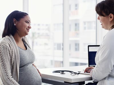 Pregnant young woman having a consultation with her doctor