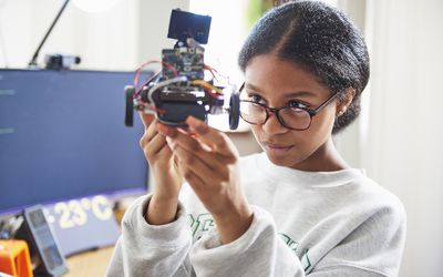 Teenage girl building robot from subscription box