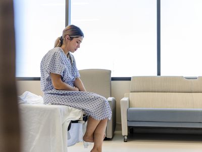 Pregnant person considers the dilation and curettage she's about to undergo