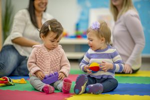 Two kids holding toys.
