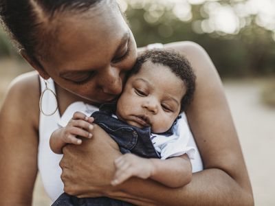 Young African American mother holding a baby