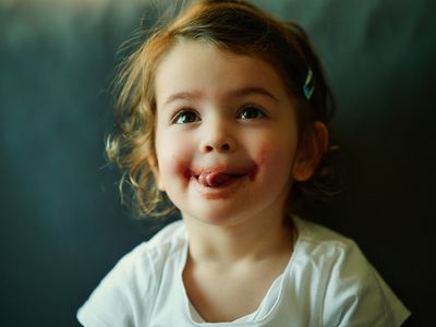 Little girl licking her lips