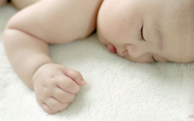 Baby girl sleeping on bed