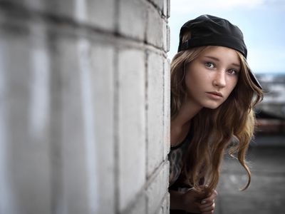 girl peeking around a corner