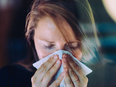 woman blowing nose