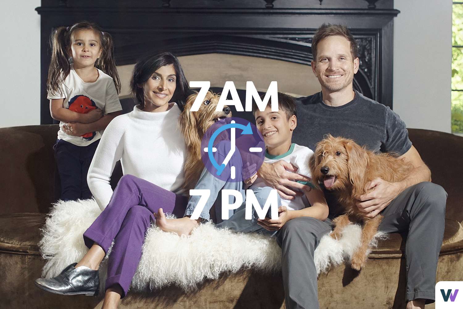 family sitting on bed