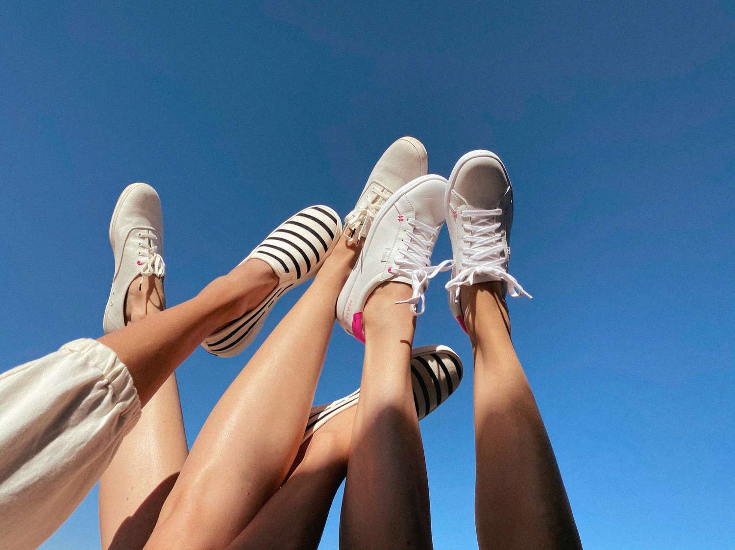 moms wearing Keds x HATCH sneakers with legs in the air