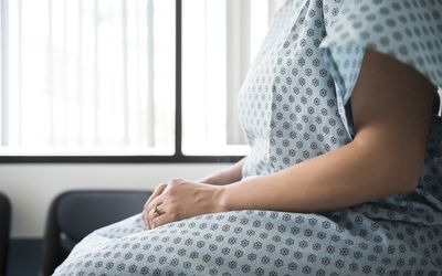 在医院检查室等候的女性患者的腹部