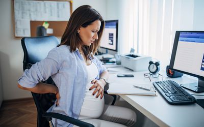 Woman experiencing painful gas toward the end of pregnancy