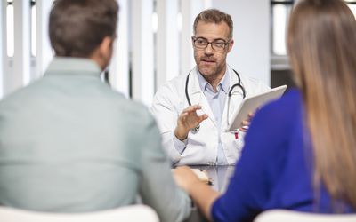Doctor speaking to couple