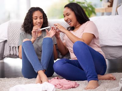 Two teenage girls looking at a tampon