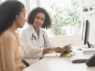 Doctor talking with a woman about the possible risk of cancer after fertility drugs and infertility
