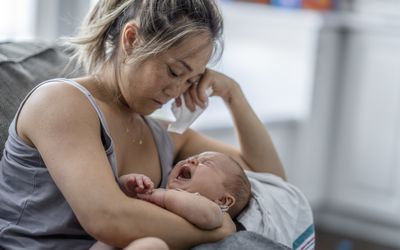Woman holding crying baby
