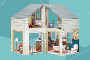 Little Tikes Stack ‘n Style Wood Dollhouse displayed on a blue patterned background