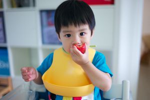 baby eating strawberry