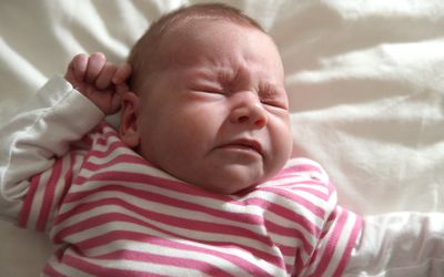 newborn baby girl sneezing