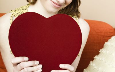 teenager holding heart shaped box