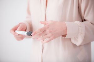 woman's hands holding black marker