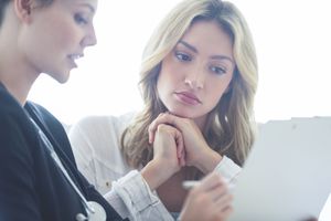 upset woman talking with healthcare provider about a miscarriage
