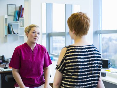 Female doctor discussing with patient in clinic