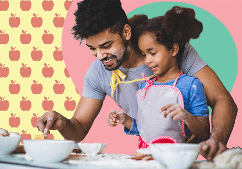 Father helping daughter cook