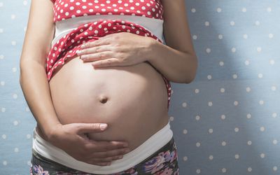 Pregnant woman showing her belly