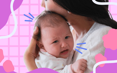 母亲抱着哭泣的婴儿