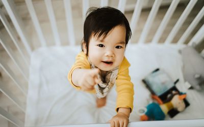Baby standing in crib