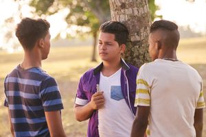 three teen boys discussing vaping