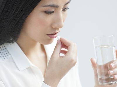 Woman taking a pill