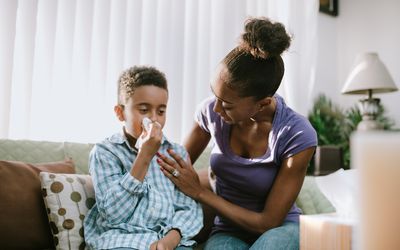 Mother comforting child using a tissue