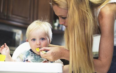 Mom feeding baby eggs