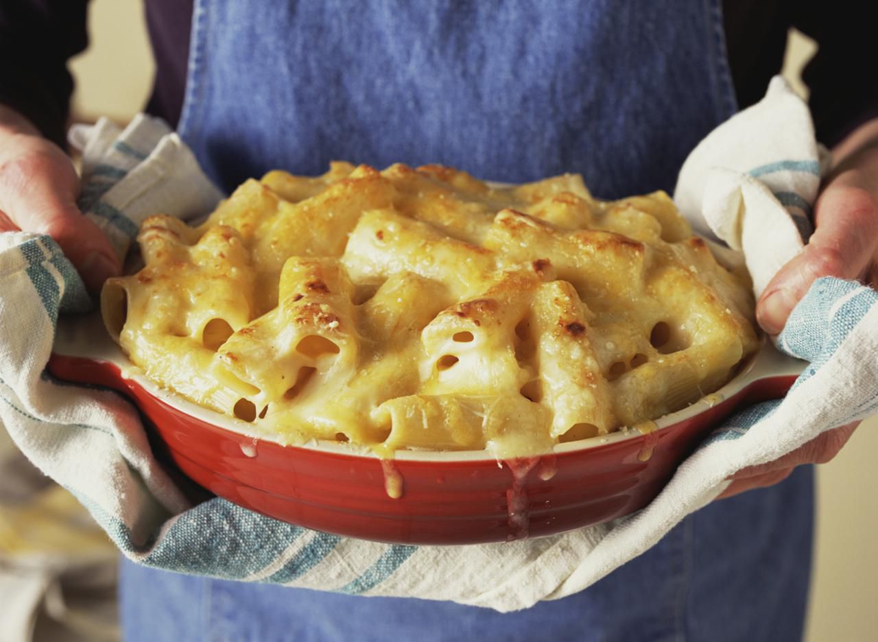 Woman holding a casserole dish of pasta