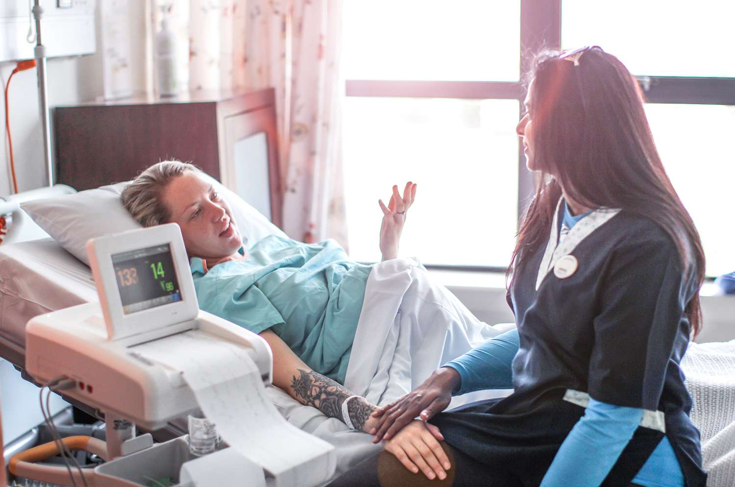 a Young pregnant woman is supported by her Doula before a caesarean section