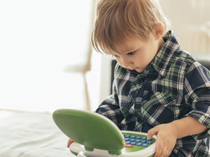 Boy using top laptop