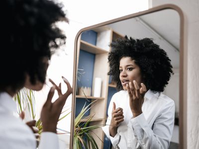 Woman applying skincare