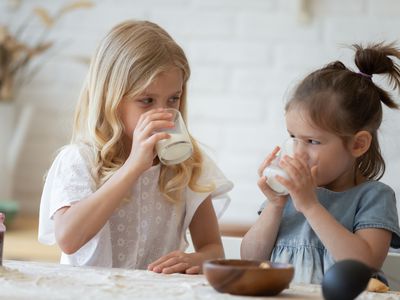 Children drinking milk at the kitchen table